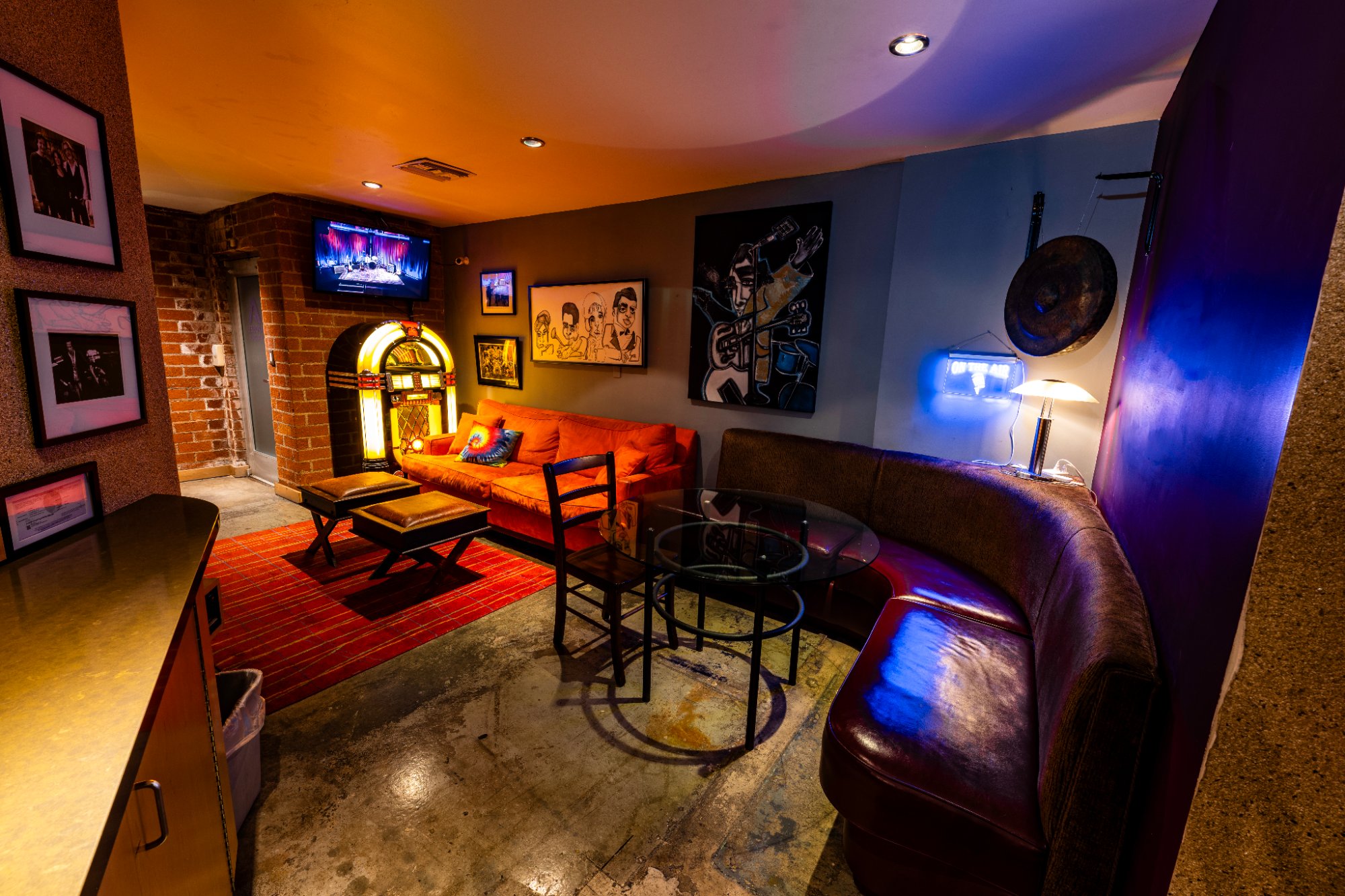 Hospitality lounge with jukebox and neon sign at Berkeley Street Studios Santa Monica