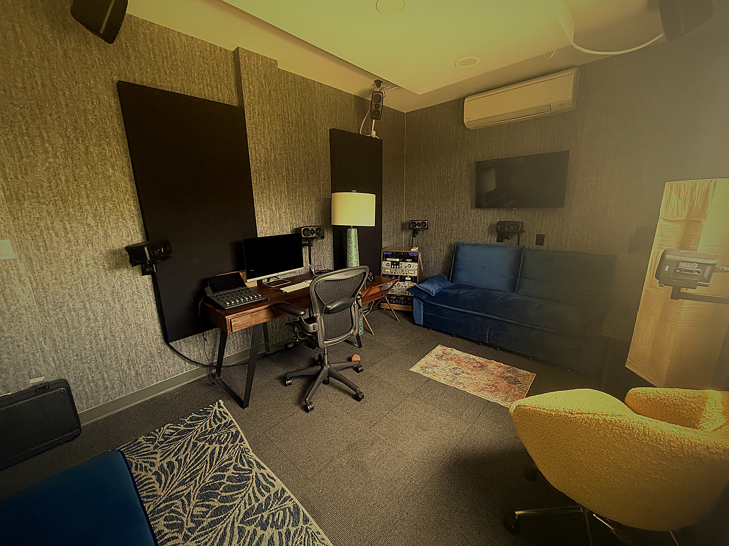 Mix This! Lounge with Dolby Atmos listening — surround monitors, Aeron chair, and lounge seating